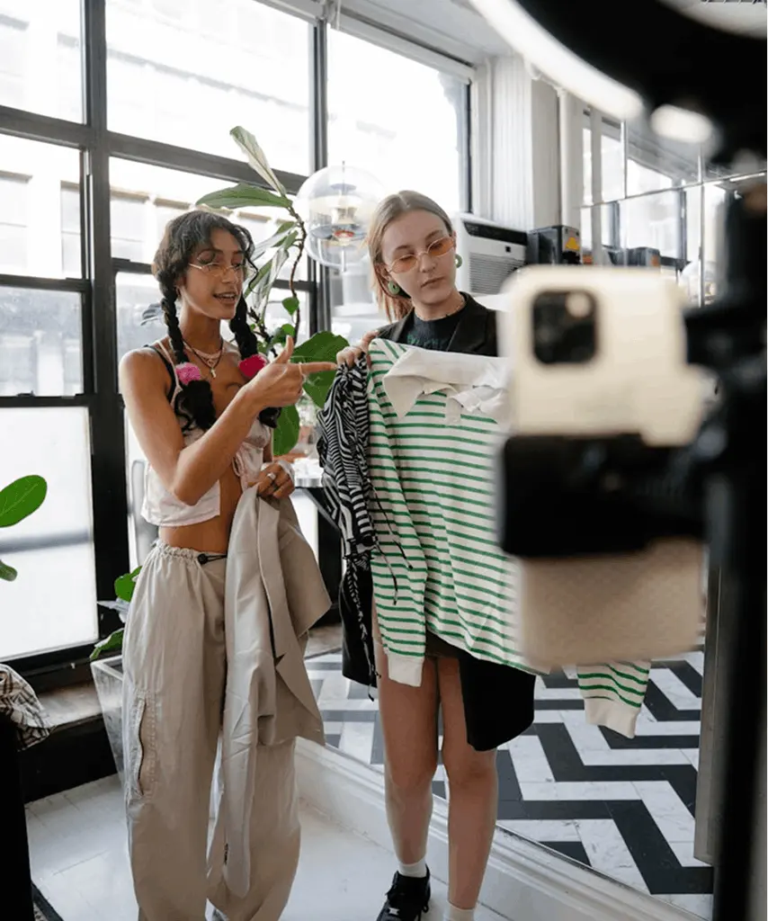 Lifestyle influencers filming social media content in a collaborative setting