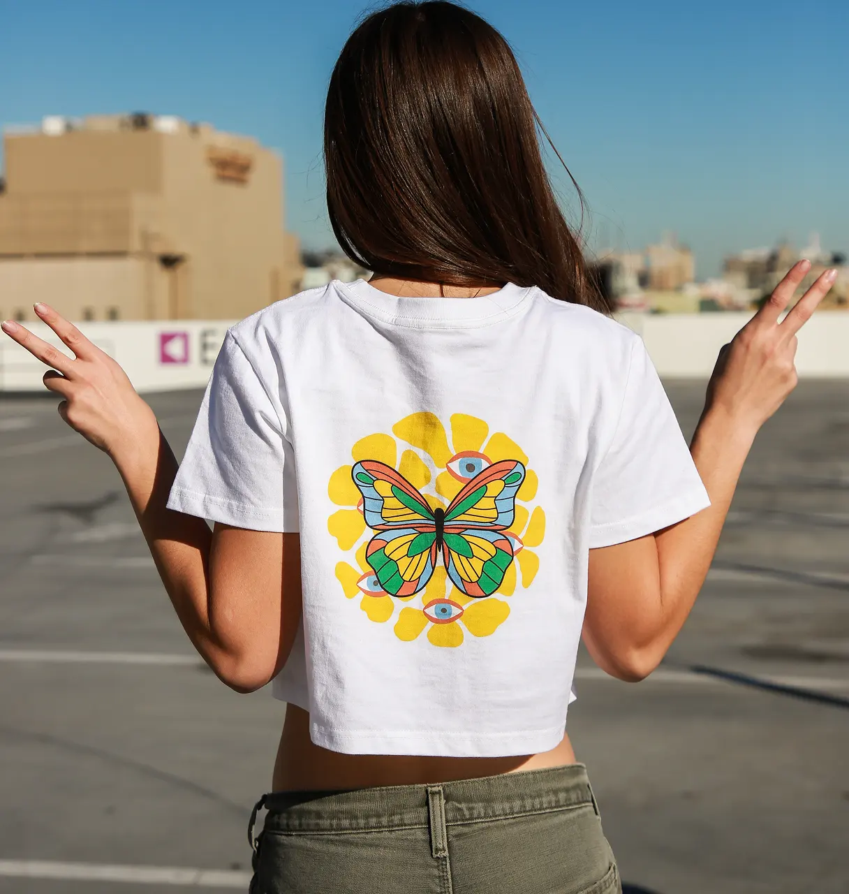 woman showing custom tshirts made by tapstitch