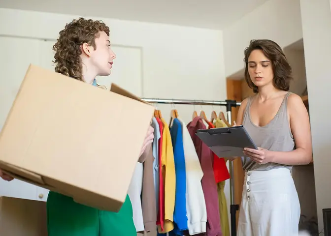 Professional apparel fulfillment workspace showing folded garments and organized inventory shelves