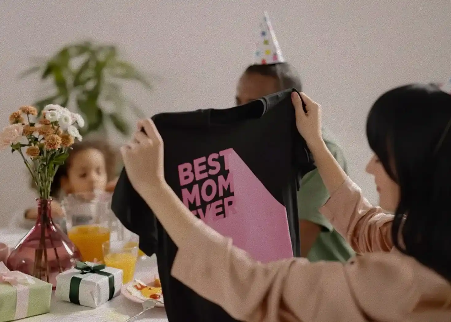 A woman took out the custom T-shirt she had prepared for her husband as a birthday present for him.