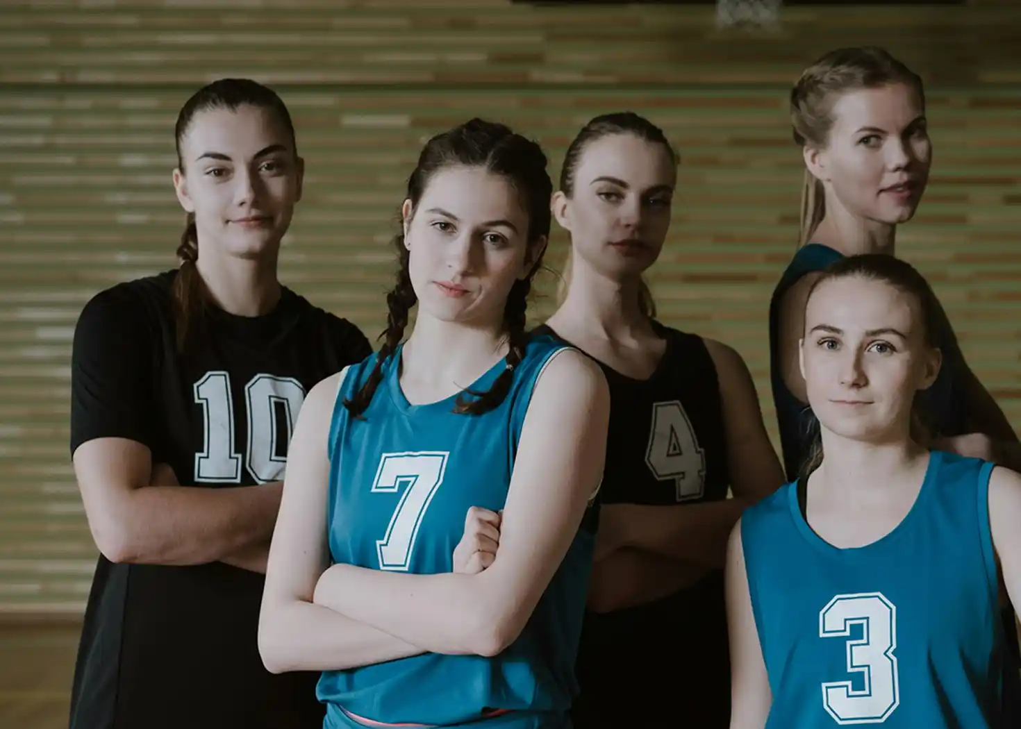 Five girls wearing custom team uniforms are preparing to participate in the competition.