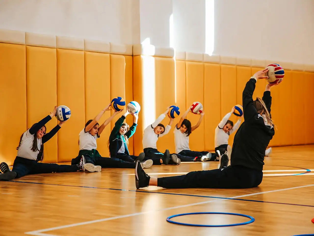 The children were wearing custom sports uniforms for the volleyball class.