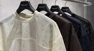 Four hollowed-out sportswear are hung on the rack
