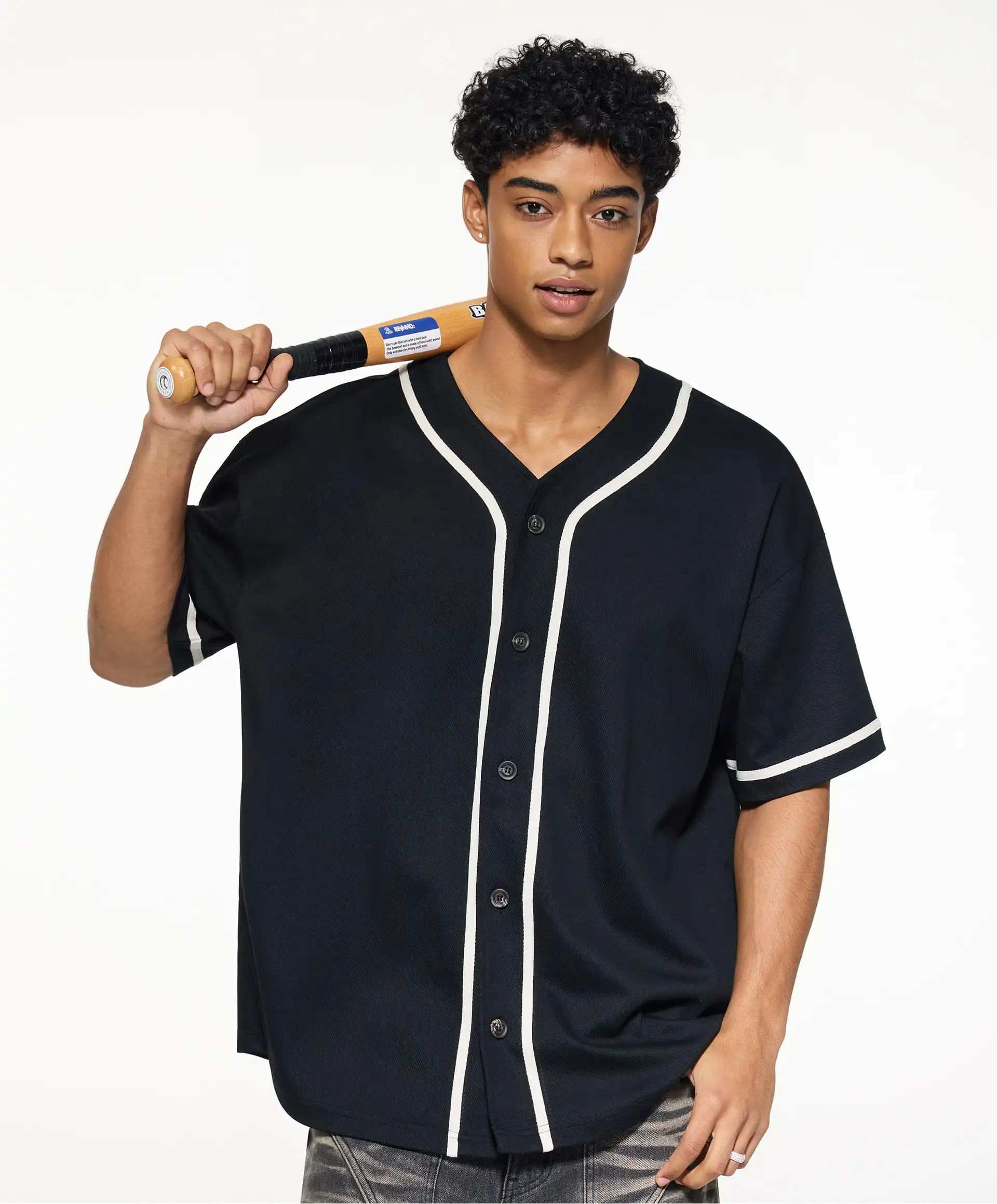 A man is holding a baseball bat and wearing a custom tapstitch sportswear